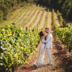Bride and groom sharing a romantic moment together in a vineyard