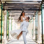 Groom lifting bride joyfully, capturing a playful and loving moment