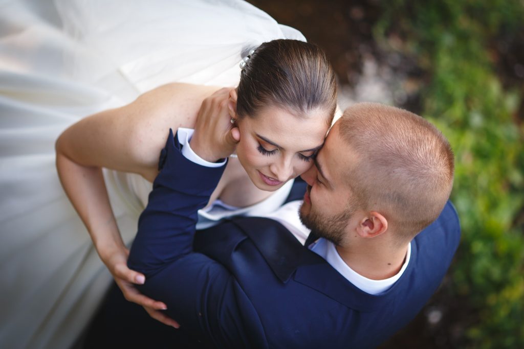Close-up of bride and groom embracing tenderly